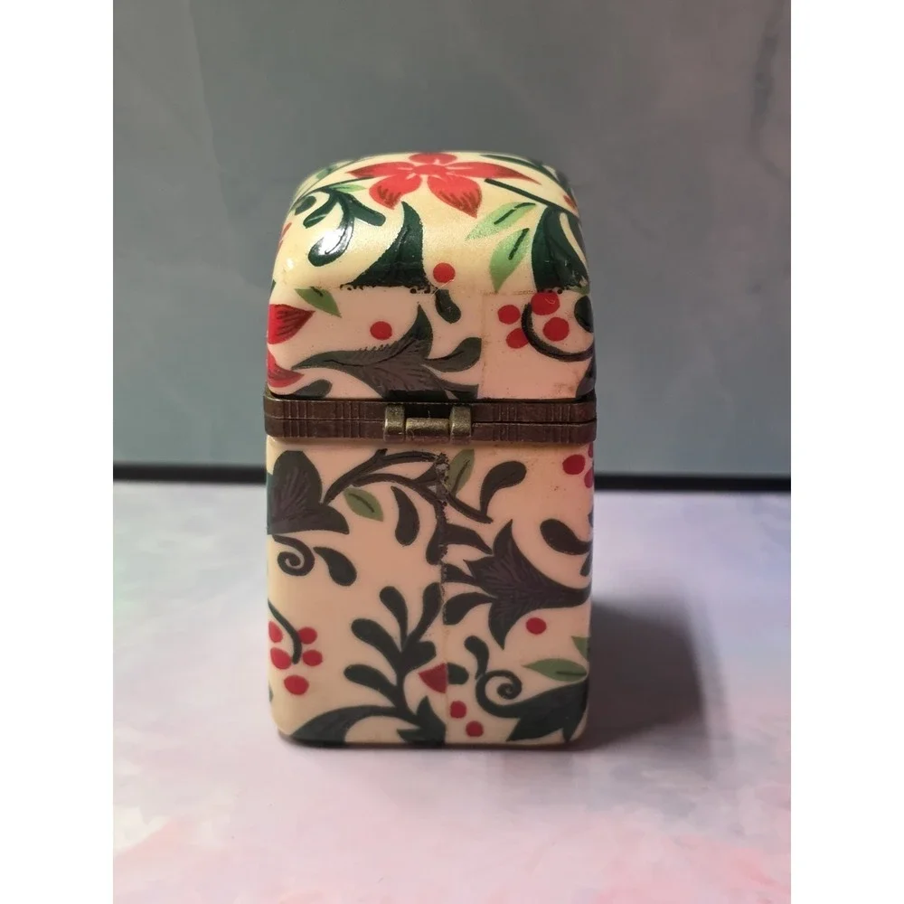 Vintage porcelain trinket box with hinged lid. Poinsettia and leaf design.